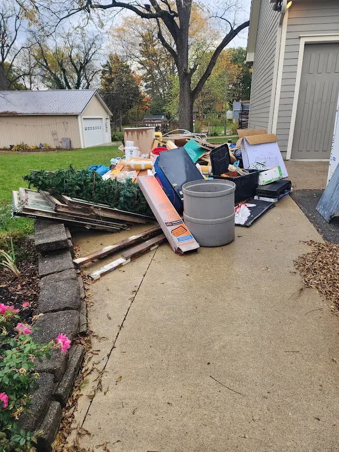 Dumpster being loaded with debris for Demolition Dumpster Rental in Hartland